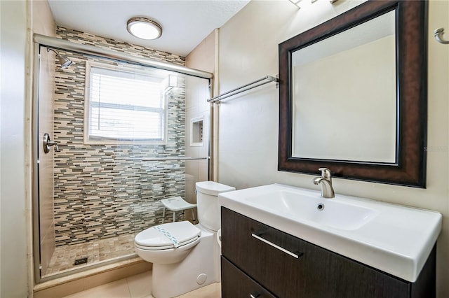 bathroom with toilet, tile patterned flooring, an enclosed shower, and vanity