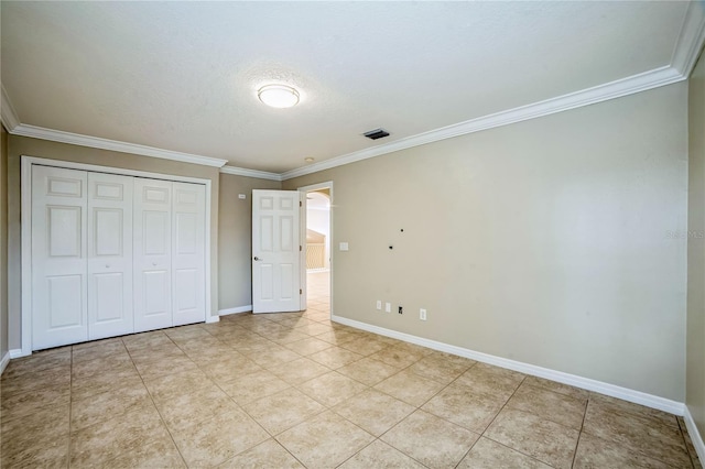 unfurnished bedroom featuring light tile patterned floors, a closet, and ornamental molding