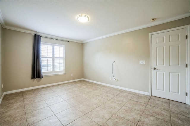 spare room featuring crown molding and light tile patterned floors