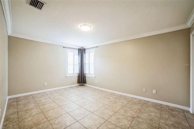 tiled empty room featuring crown molding and a textured ceiling