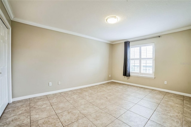 spare room with crown molding, light tile patterned flooring, and a textured ceiling