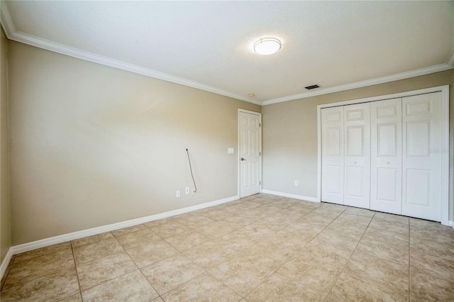 unfurnished bedroom featuring light tile patterned floors, a closet, and crown molding