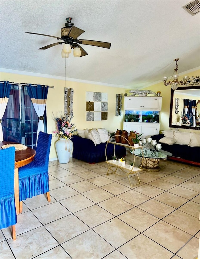 living room featuring a textured ceiling, light tile patterned floors, crown molding, and ceiling fan with notable chandelier