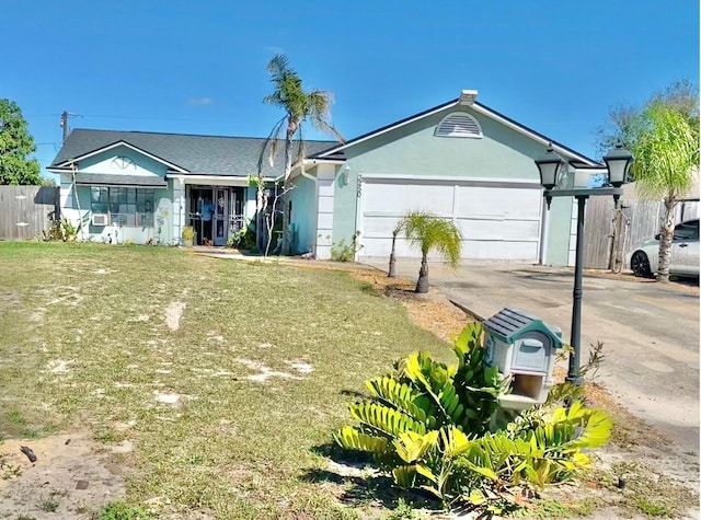 ranch-style home featuring a garage, a front lawn, concrete driveway, and stucco siding