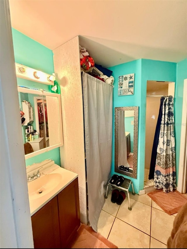 bathroom with a shower stall, vanity, and tile patterned floors