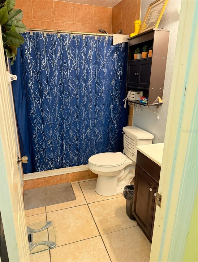 full bathroom with a shower with curtain, vanity, toilet, and tile patterned floors