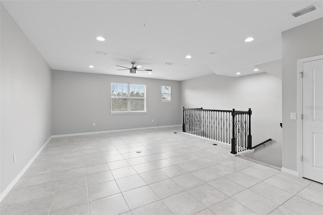 tiled empty room with ceiling fan