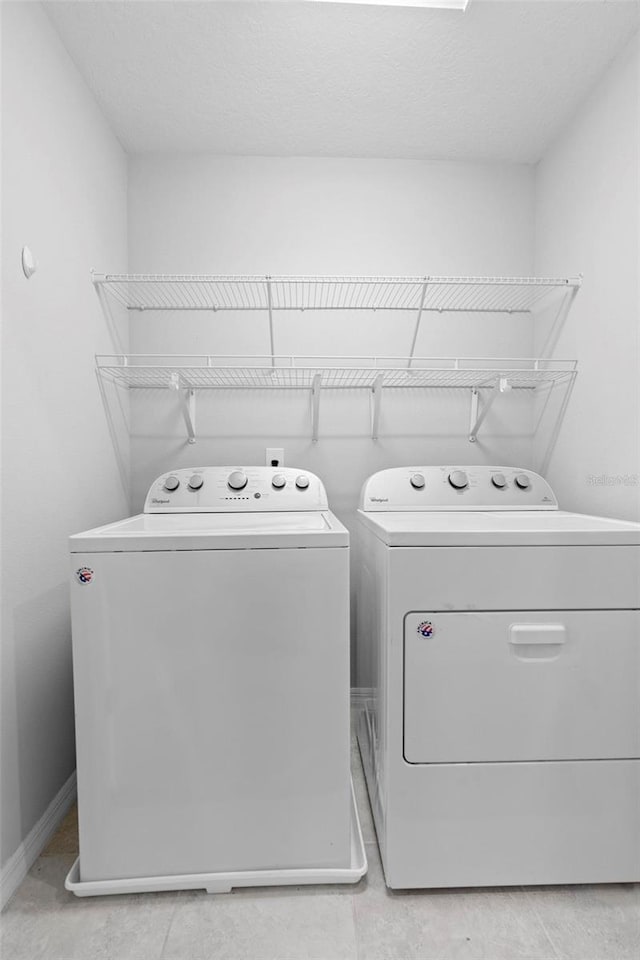 clothes washing area with washing machine and clothes dryer