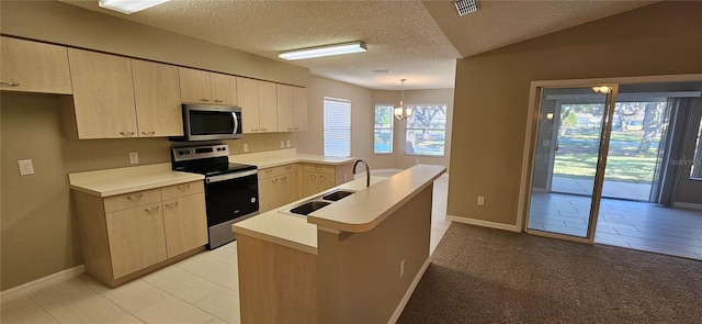 kitchen featuring kitchen peninsula, light brown cabinets, stainless steel appliances, and pendant lighting