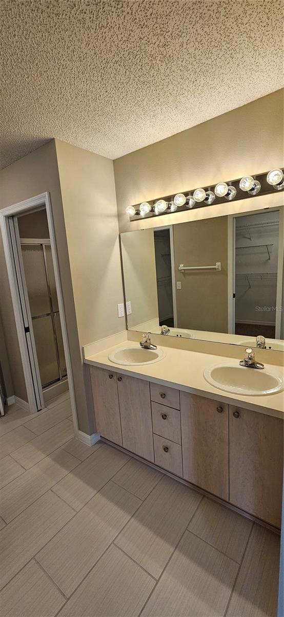 bathroom featuring a textured ceiling and vanity