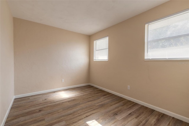 spare room with hardwood / wood-style floors and a wealth of natural light