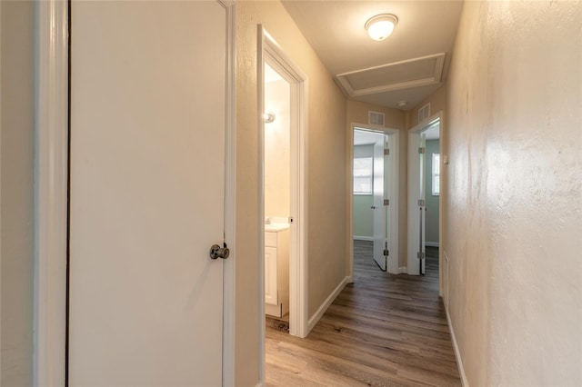 hallway with light hardwood / wood-style floors