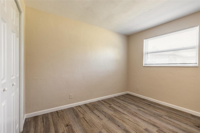 spare room with hardwood / wood-style flooring