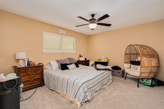 bedroom with light colored carpet, a textured ceiling, and ceiling fan