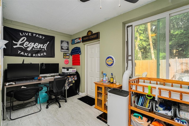 office space featuring ceiling fan and a textured ceiling