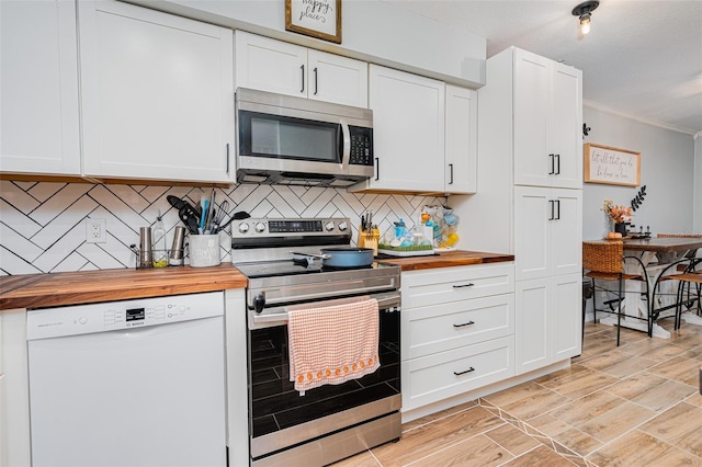 kitchen featuring crown molding, wooden counters, appliances with stainless steel finishes, white cabinetry, and tasteful backsplash