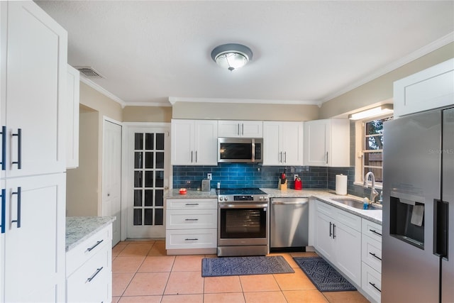 1309 Paradise Ln, Winter Park, FL 32792 - kitchen with sink, white cabinets, and appliances with stainless steel finishes