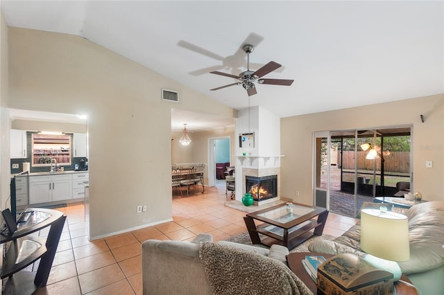 1309 Paradise Ln, Winter Park, FL 32792 - tiled living room featuring a multi sided fireplace, sink, lofted ceiling, and ceiling fan