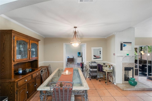 1309 Paradise Ln, Winter Park, FL 32792 - dining space with a brick fireplace, ornamental molding, light tile patterned floors, and a textured ceiling
