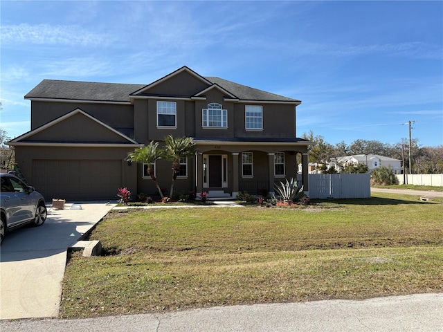 view of front of property with a garage, a front lawn, and covered porch