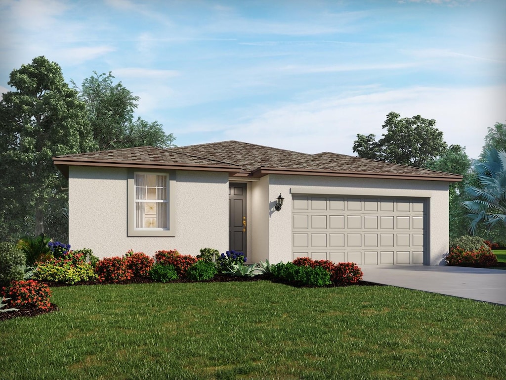 view of front of home with a garage and a front lawn