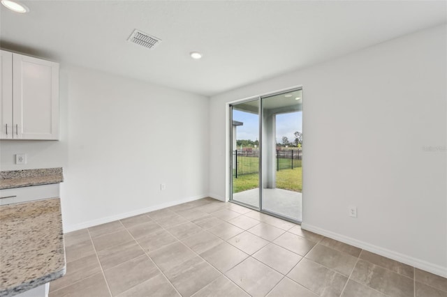 empty room featuring visible vents, recessed lighting, baseboards, and light tile patterned floors