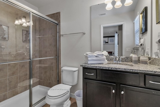 bathroom featuring walk in shower, vanity, and toilet