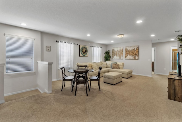 carpeted living room featuring a textured ceiling