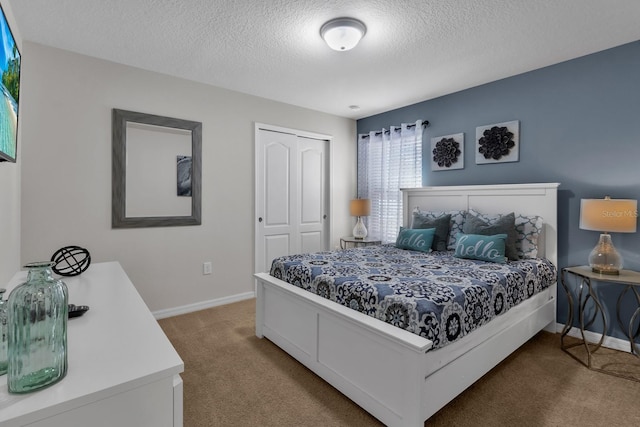 carpeted bedroom with a textured ceiling and a closet