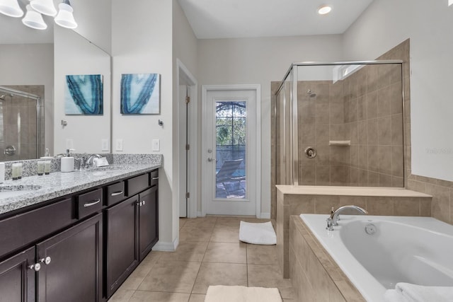 bathroom featuring vanity, independent shower and bath, and tile patterned floors