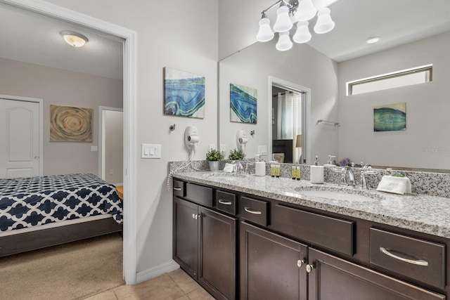 bathroom featuring tile patterned floors, vanity, and a notable chandelier