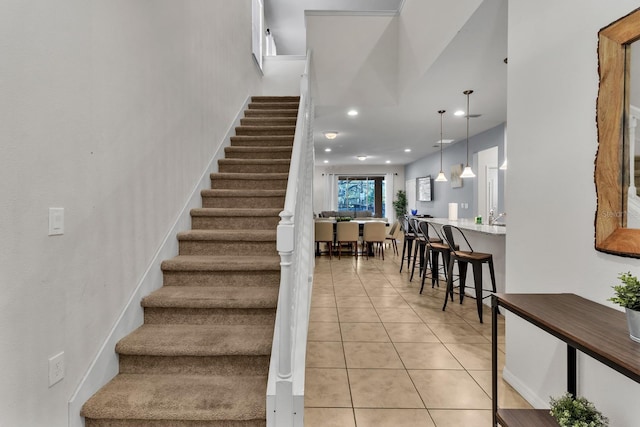 stairway with tile patterned floors