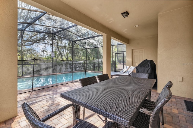 view of patio / terrace with a fenced in pool, glass enclosure, and a grill