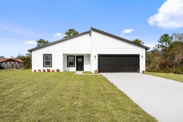 view of front of house with a garage and a front yard