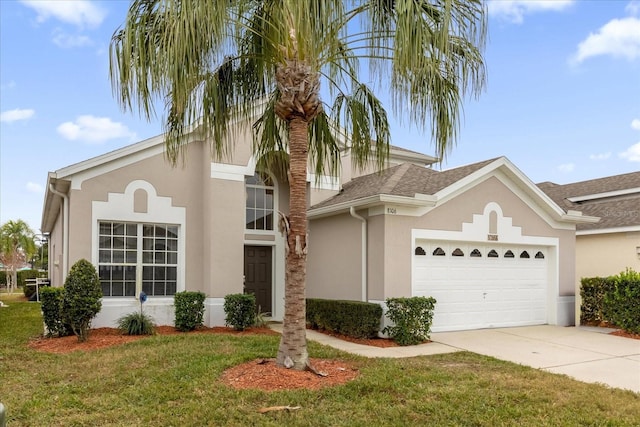 view of front of home with a front lawn and a garage