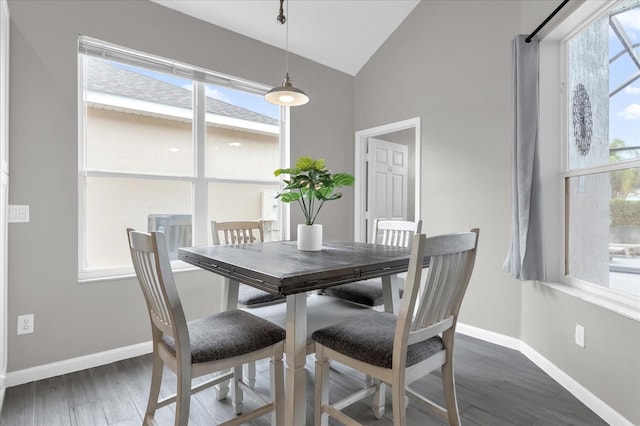 dining room featuring vaulted ceiling and dark hardwood / wood-style floors