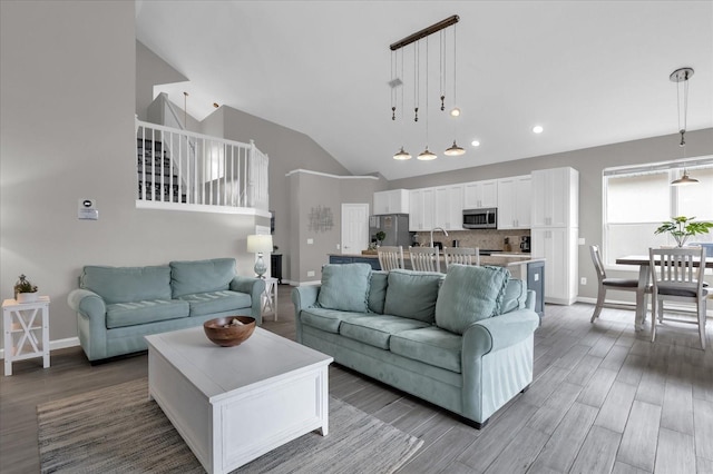 living room with lofted ceiling and hardwood / wood-style floors