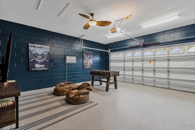 rec room with ceiling fan, a textured ceiling, and a wall unit AC