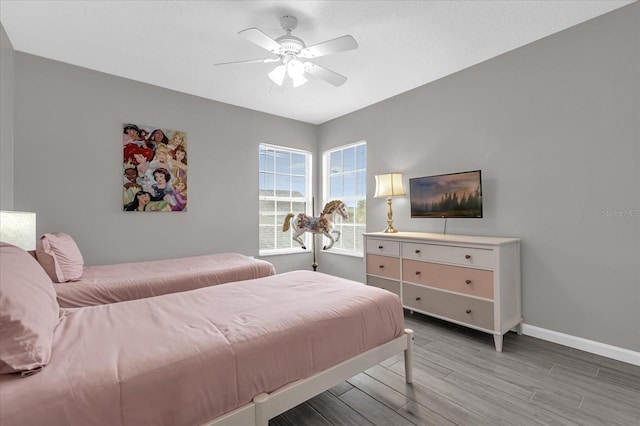 bedroom featuring ceiling fan and hardwood / wood-style flooring