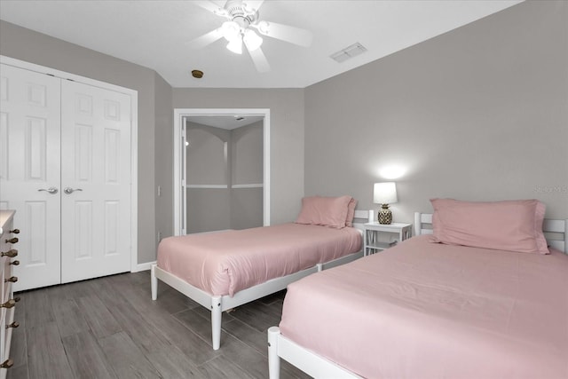 bedroom featuring ceiling fan, a closet, and wood-type flooring