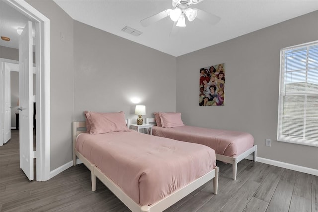 bedroom with ceiling fan and wood-type flooring