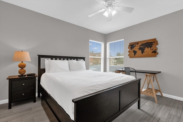 bedroom with ceiling fan and light hardwood / wood-style flooring