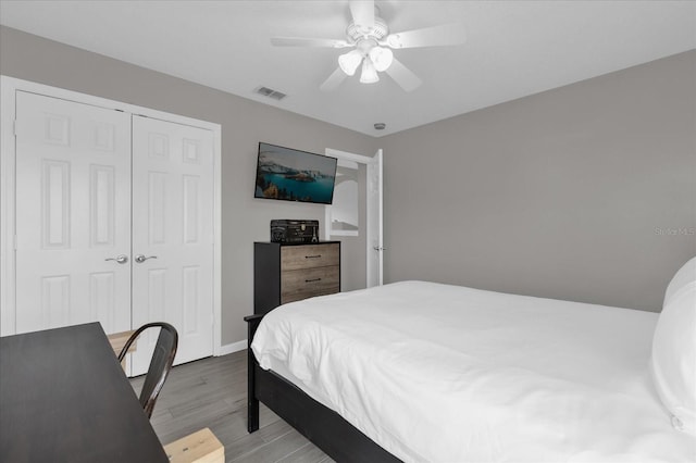 bedroom featuring ceiling fan, a closet, and light hardwood / wood-style flooring