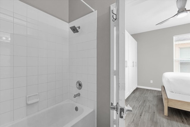 bathroom featuring ceiling fan, tiled shower / bath, and hardwood / wood-style floors