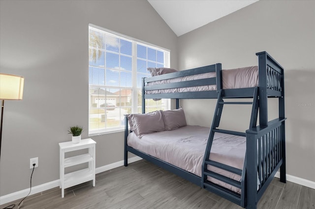 bedroom featuring vaulted ceiling and wood-type flooring