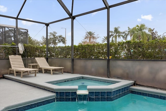 view of swimming pool with a patio area, glass enclosure, and an in ground hot tub