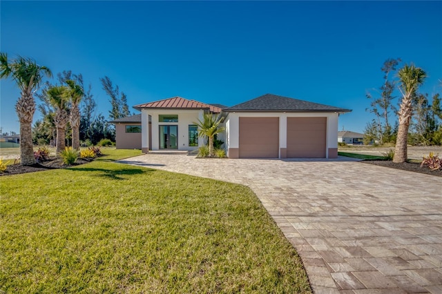 view of front facade with a garage and a front lawn