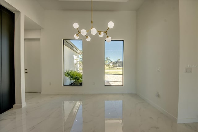 unfurnished dining area with a notable chandelier