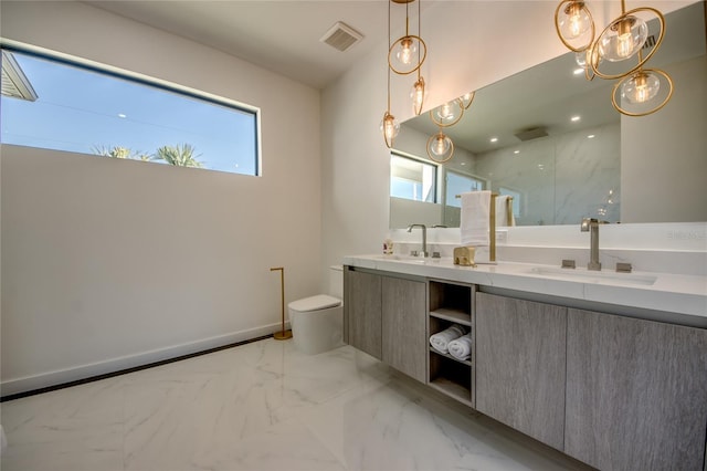 bathroom with toilet, a wealth of natural light, a shower, and vanity