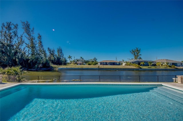 view of swimming pool featuring a water view